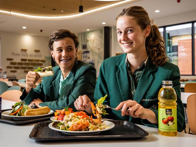 Westminister's new dining area promotes community togetherness.  Eliza Maloney, year 10, with a Thai noodle salad and Charlie Bradford, year 9, with a chicken salad sandwich, on February 1st, 2023, in Marion.Picture: Tom Huntley