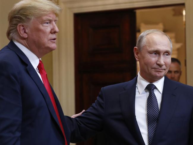 U.S. President Donald Trump, left, and Russian President Vladimir Putin leave a press conference after their meeting at the Presidential Palace in Helsinki, Finland, Monday, July 16, 2018. (AP Photo/Pablo Martinez Monsivais)
