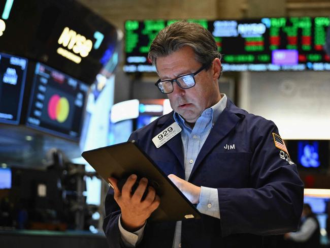 Traders work on the floor of the New York Stock Exchange (NYSE) at the opening bell on November 13, 2024, in New York City. (Photo by ANGELA WEISS / AFP)