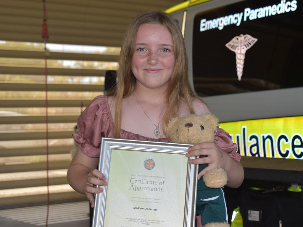 Madison Jennings accepted her certificate of appreciation at Mackay South Ambulance station after rescuing her cousin from drowning. Picture: Lillian Watkins