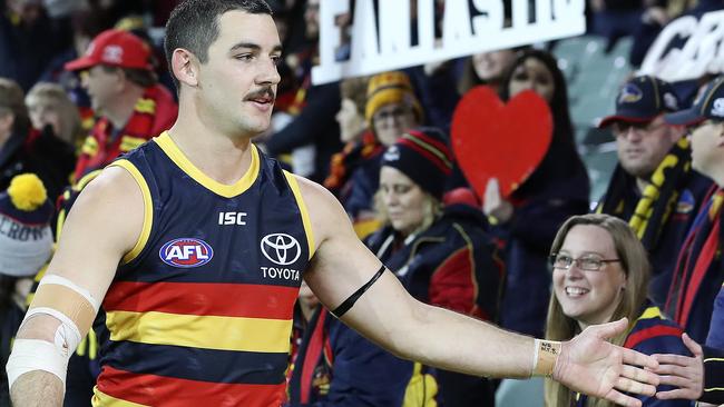 Taylor Walker walks past fans at the Adelaide Oval after a win against St Kilda in round 20 of last year. Picture: Sarah Reed