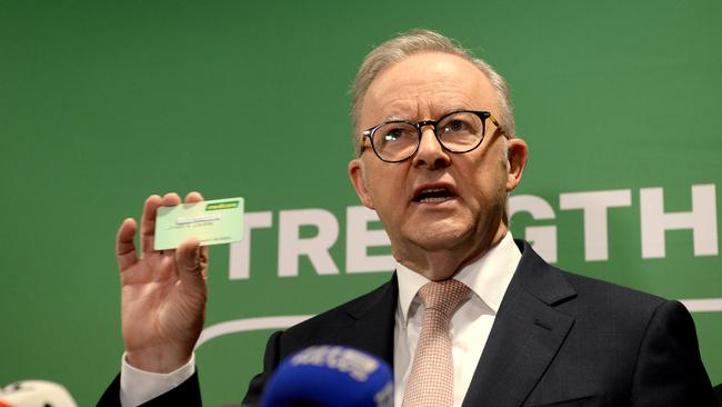 Prime Minister Anthony Albanese holds up a Medicare card during a press conference. Picture: Andrew Henshaw