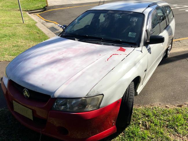 A damaged Holden Commodore abandoned in Quirk Rd, Manly Vale, after a police pursuit which led to a string of charges being laid against the alleged driver. Picture: Jim O'Rourke