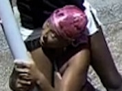 The woman was charged with larceny for stealing a flag from Sydney's Eastern suburb on Christmas day. She is shown wearing a camouflage print bikini top, white shorts, dark shoes and a pink head scarf.