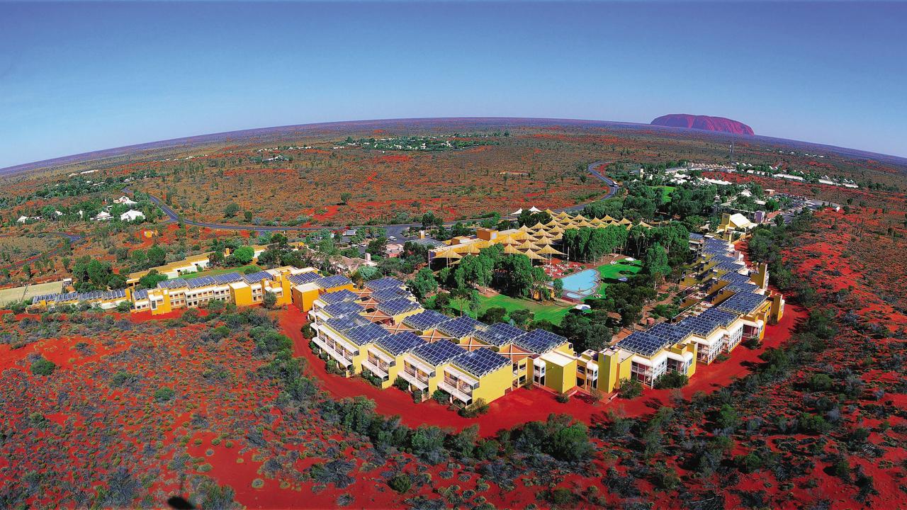 An aerial shot of Ayers Rock Resort with Uluru in the background. Picture: Voyages Tourism Australia