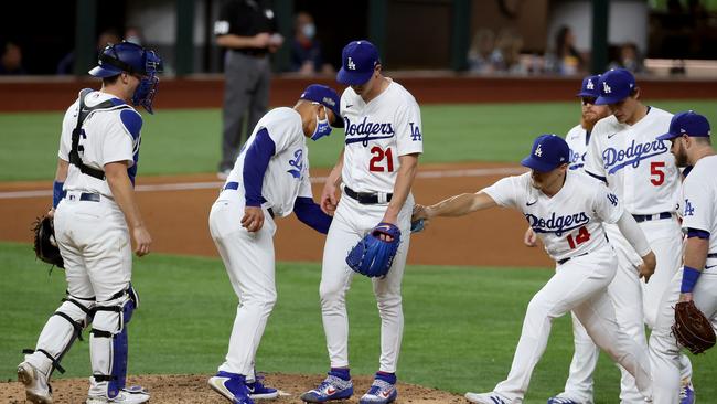 ARLINGTON, TEXAS - OCTOBER 12: Dave Roberts #30 of the Los Angeles Dodgers pulls Walker Buehler #21 during the sixth inning against the Atlanta Braves in Game One of the National League Championship Series at Globe Life Field on October 12, 2020 in Arlington, Texas. (Photo by Tom Pennington/Getty Images)