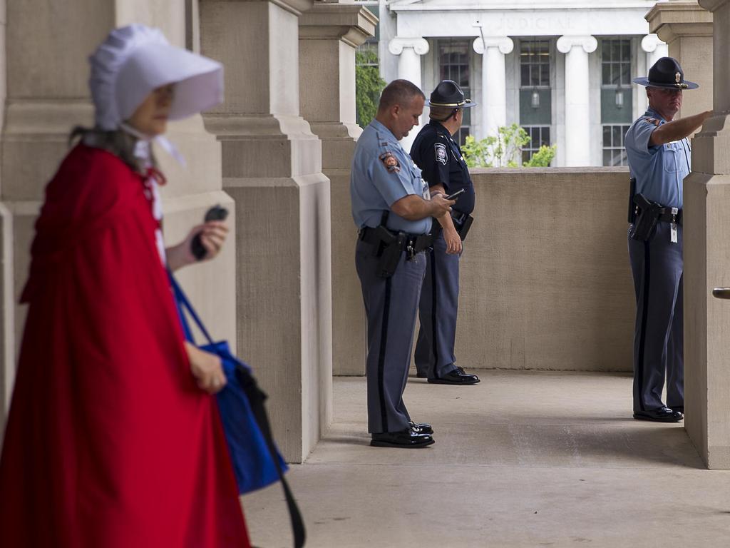 Police watch protesters rally outside the Georgia State Capitol building in Atlanta on May 7. Picture: AP