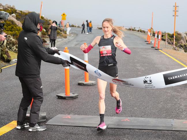 Winner in the women's event for the 2022 Point to Pinnacle Millie Clark crosses the line in 1:40:21. Picture: Robert Groom/ RaceAtlas