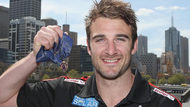 MELBOURNE, AUSTRALIA - SEPTEMBER 25:  2012 Brownlow Medallist Jobe Watson of the Essendon Bombers AFL team poses holding the Brownlow Medal at a press conference at Crown Promenade on September 25, 2012 in Melbourne, Australia.  (Photo by Scott Barbour/Getty Images)