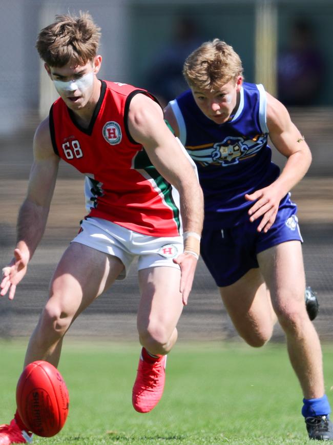 Sacred Heart’s Adam Bunworth chases Henley’s Taj Schofield during the All Schools Cup preliminary final. Picture Matt Turner.