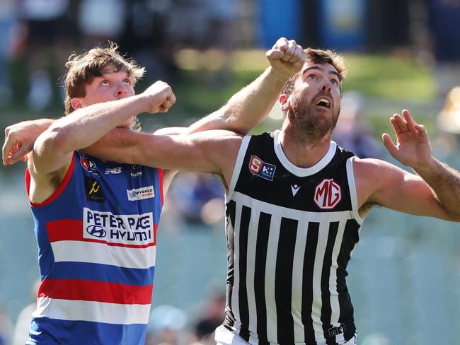 Billy McCormack (left) battling it out with Scott Lycett in the SANFL.