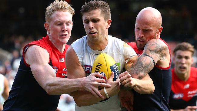 Marc Murphy is tackled by Clayton Oliver and Nathan Jones. Picture: Wayne Ludbey