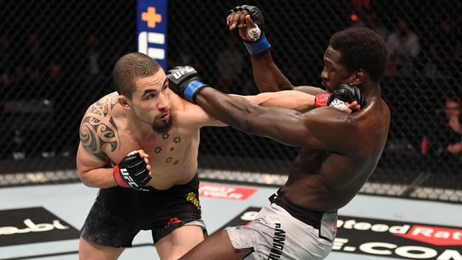 Robert Whittaker lands a blow to Jared Cannonier in their middleweight bout during the UFC 254 event in October. Picture: Josh Hedges/Zuffa LLC via Getty Images