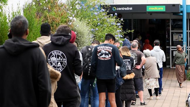 People line up at a Centrelink office in Flemington, Melbourne, on March 23.