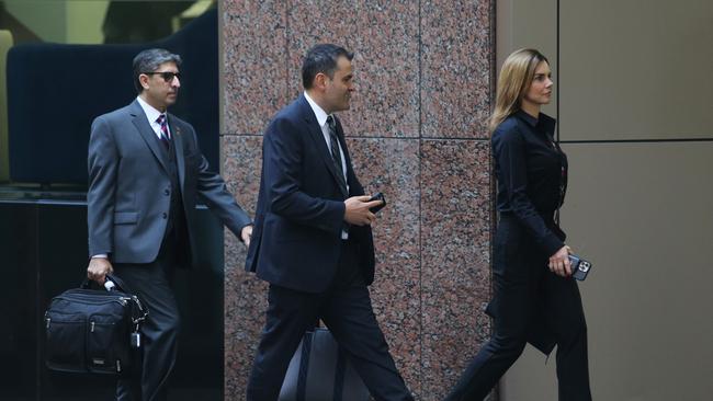 Magnis US managing director Hoshi Daruwalla, and chair Frank Poullas and an unidentified woman arrive for their AGM. Picture: John Feder/The Australian