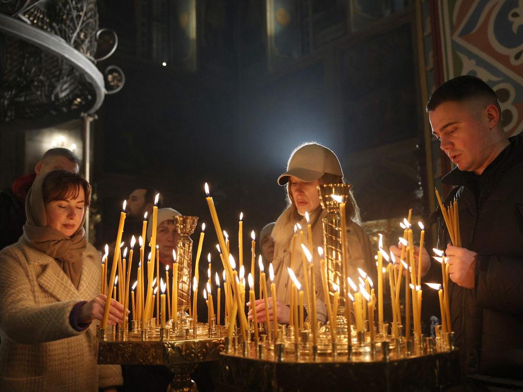 Believers light candles during a Christmas service in St. Michael's Cathedral in Kyiv, on December 24, 2024, amid the Russian invasion in Ukraine. Picture: AFP