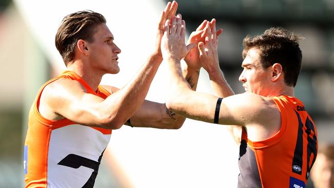 Rory Lobb and Jeremy Cameron celebrate a Giants goal.