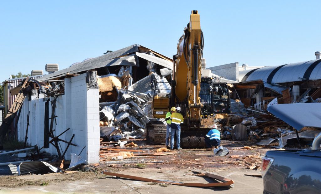 DEMO TIME: Demolition of the old Town and Country buildings on Brisbane St began today. Picture: Helen Spelitis