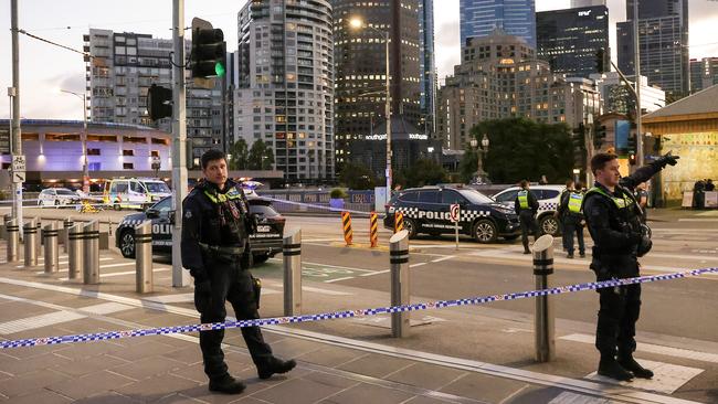 Police on Princes Bridge outside Flinders Street Station. Picture: Ian Currie