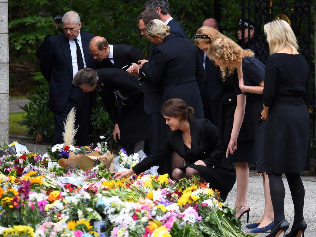 The royals inspect the flowers and tributes left outside Balmoral in honour of the Queen. Picture: AFP