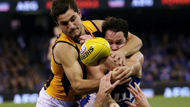 North Melbourne’s Sam Gibson is tackled high by Hawthorn opponent Daniel Howe. Picture: Colleen Petch