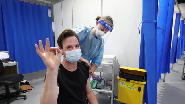 Anthony Naus, 30, recieves his AZ vaccination at the Melbourne Convention and Exhibition Centre. Picture: David Caird