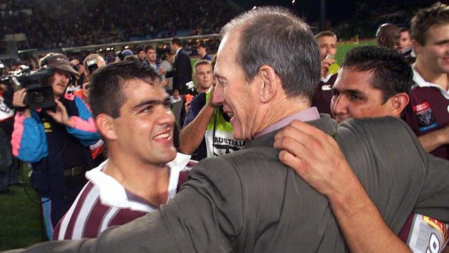 Coach Wayne Bennett embraces John Buttigieg (L) &amp; John Doyle after Queensland defeated NSW in game 3 of the 2001 State of Origin series.