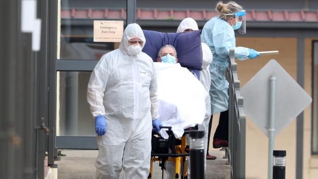 Residents of Melbourne’s St Basil’s aged-care home are taken by ambulance. Picture: NCA NewsWire / David Crosling