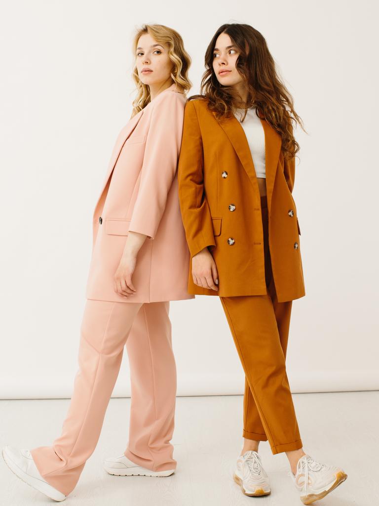 Stylish young women in pastel outfits standing together. Picture: iStock
