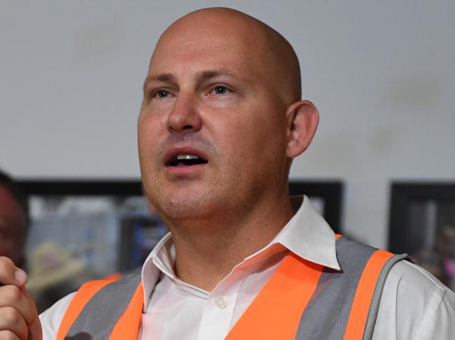 Queensland Premier Annastacia Palaszczuk (left) watches Treasurer Curtis Pitt speaking at a press conference during a visit to a construction site in Cairns, Monday, November 20, 2017. Ms Palaszczuk is on the campaign trail ahead of the November 25 state election. (AAP Image/Dan Peled) NO ARCHIVING