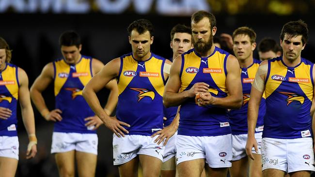 Eagles players walk off Etihad Stadium after their loss to Collingwood. Picture: AAP