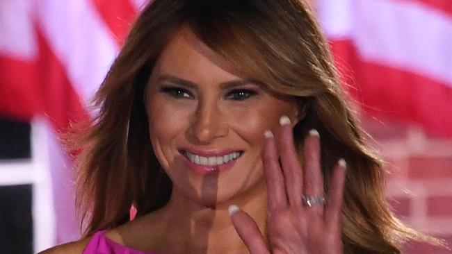 US President Donald Trump gestures as US First Lady Melania Trump waves to guests at the conclusion of the third night of the Republican National Convention at Fort McHenry National Monument in Baltimore, Maryland, August 26, 2020. (Photo by SAUL LOEB / AFP)