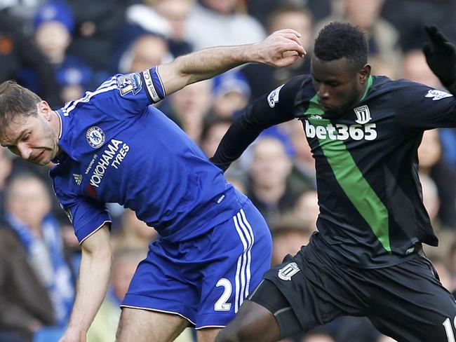 Chelsea's Branislav Ivanovic, left, and Stoke City's Mame Biram Diouf battle for the ball during their English Premier League soccer match at Stamford Bridge, London, Saturday, March 5, 2016. (Steve Paston/PA via AP) UNITED KINGDOM OUT - NO SALES - NO ARCHIVES