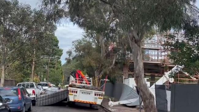 Bertram Street at Hackney is closed in both directs after a crane’s main boom has snapped and dropped its load onto nearby parked cars. picture Nine News