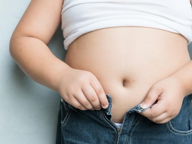 The size of stomach of fat boy with overweight.