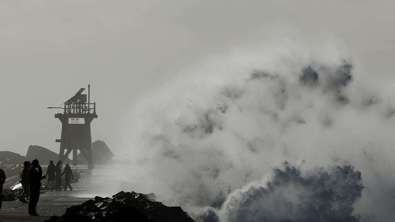 Sea spray looms over the breakwall. Picture: Peter Lorimer.