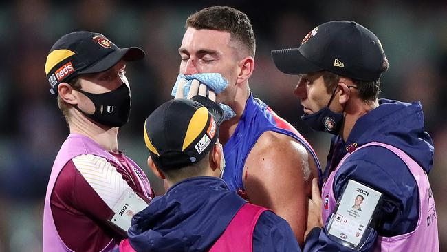 Dan McStay is helped off the ground after a brutal knock to his head. Picture: Getty Images