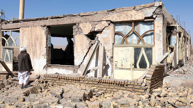 An Afghan man stands near a damaged house after the earthquakes in Sarbuland village in the Zendeh Jan district of Herat province on Sunday. Picture: AFP