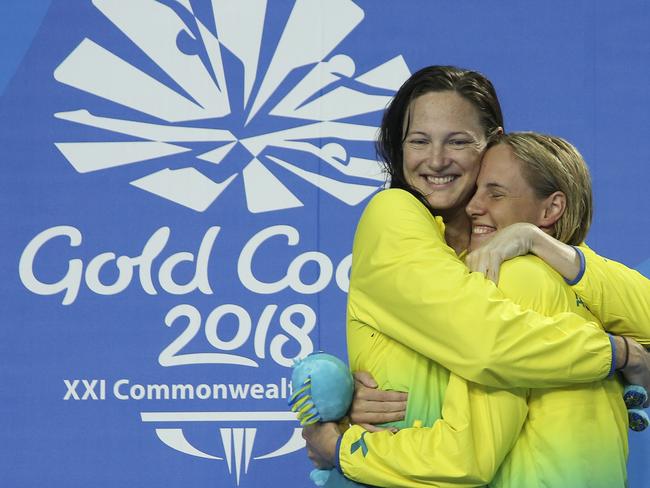 Australia's Bronte Campbell, right, is hugged by silver medalist Cate Campbell also from Australia after winning gold and also setting a new games record in the women's 100m freestyle final at Aquatic Centre during the 2018 Commonwealth Games on the Gold Coast, Australia, Monday, April 9, 2018. (AP Photo/Rick Rycroft)
