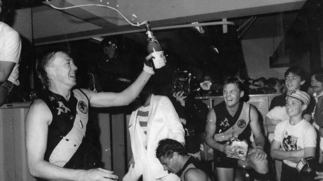 Tony Symonds, Scott Salisbury and teammates in change rooms after winning the 1985 flag.