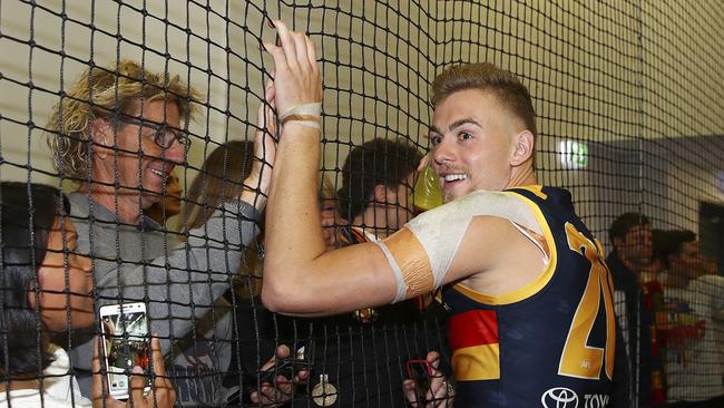 Adelaide’s Hugh Greenwood after the preliminary final win in the rooms with family and friends.  Picture: Sarah Reed