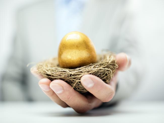 Retirement savings golden nest egg in a businessman's hand, superannuation generic