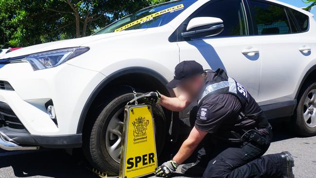 A SPER enforcement officer clamping a vehicle.