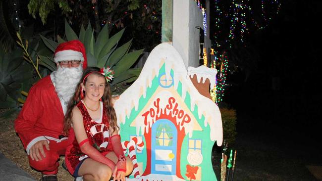 CHRISTMAS FUN: Santa (aka Damian Langdon) and Gypsy Russell, 11, at the Leith Place Christmas lights. Picture: Michele Sternberg