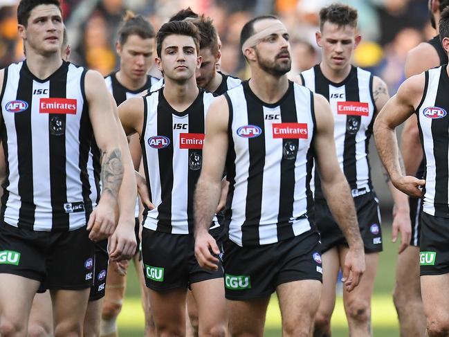 Magpies players leave the ground after the Round 17 AFL match between the Collingwood Magpies and the West Coast Eagles at the MCG in Melbourne, Sunday, July 15, 2018. (AAP Image/Julian Smith) NO ARCHIVING, EDITORIAL USE ONLY