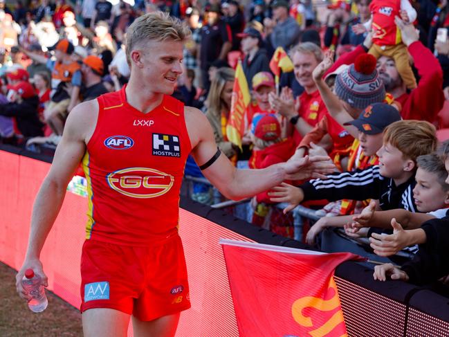 Bodhi Uwland of the Suns interacts with fans during the 2024 AFL match between the Gold Coast Suns and Port Adelaide Power. Picture: Russell Freeman/AFL Photos via Getty Images.