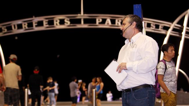 Preacher Cameron Guy delivers sermons via a speaker to walkers down Cavill Mall. Picture: Scott Fletcher