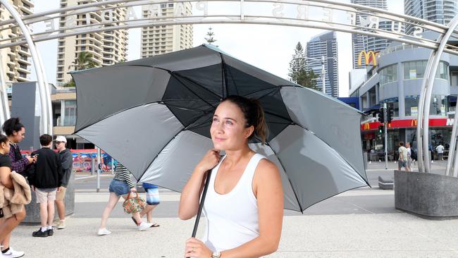 The Gold Coast is set to cop a major downpour this week. Kate Leso is pictured at Surfers Paradise. Picture: Richard Gosling