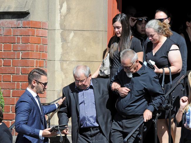 Mourners leave the service. Picture: AAP