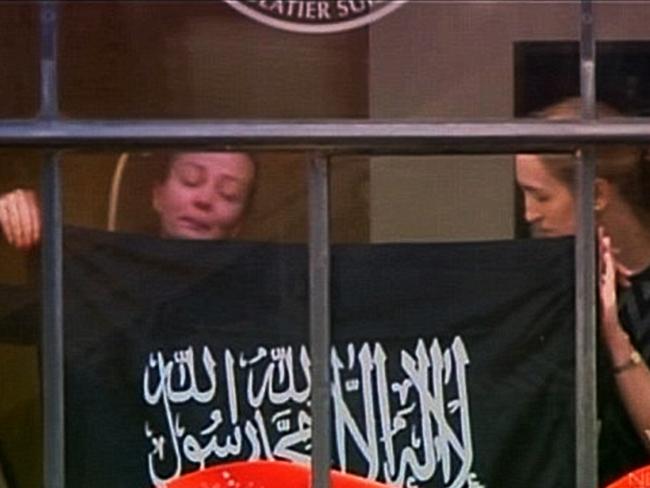 Marcia Mikhael is pictured in the window of the Lindt Cafe during the siege with Katrina Dawson (right).